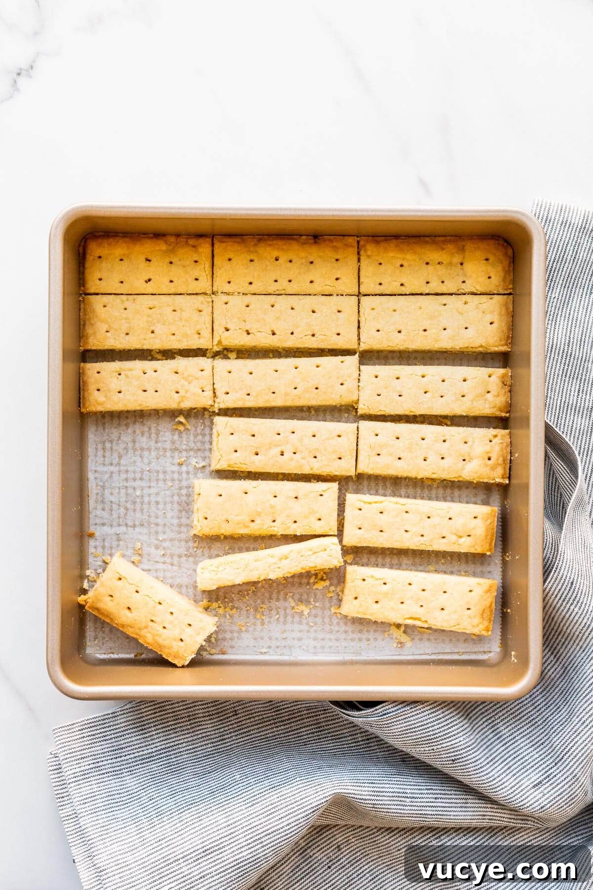 A pan of buttery shortbread cookies cut into sticks.