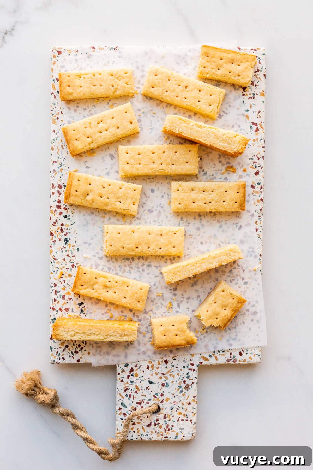 Shortbread cookie sticks on a terrazzo platter.