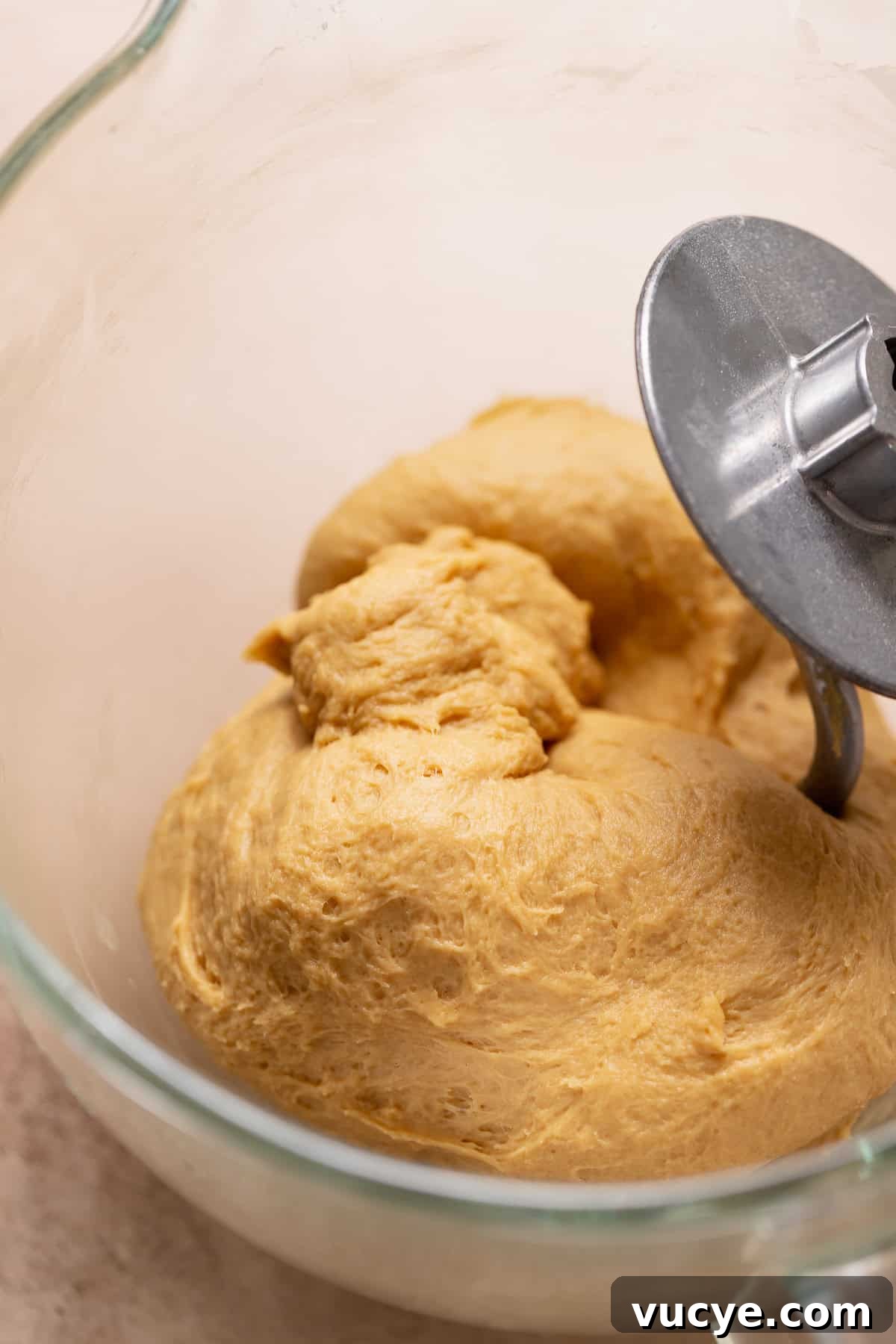 Ultra-Soft Gingerbread Cinnamon Rolls with Molasses Swirl 4 Molasses yeast dough for gingerbread rolls in a stand mixer bowl.