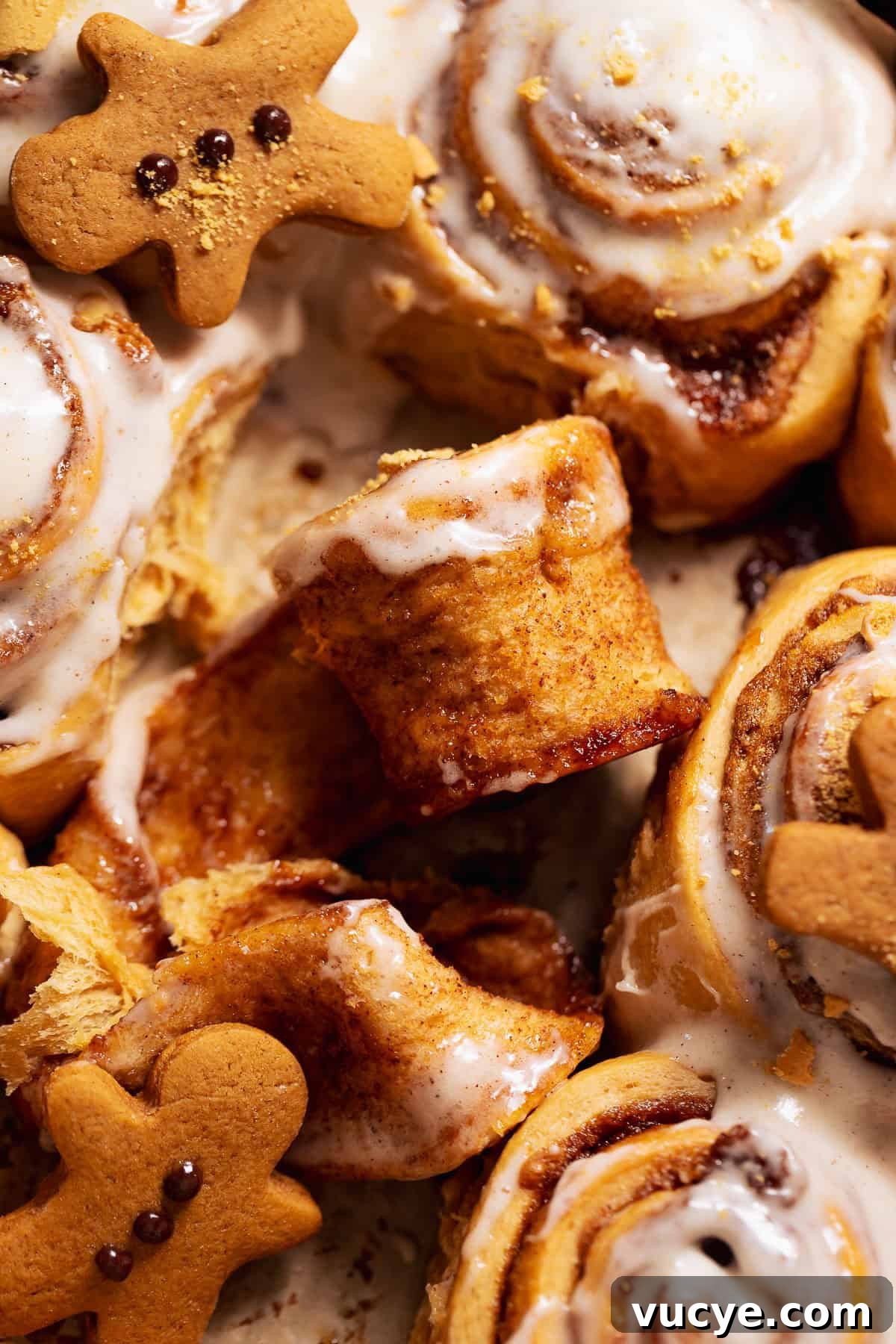 Ultra-Soft Gingerbread Cinnamon Rolls with Molasses Swirl 9 A gingerbread bun half unrolled in a baking pan.