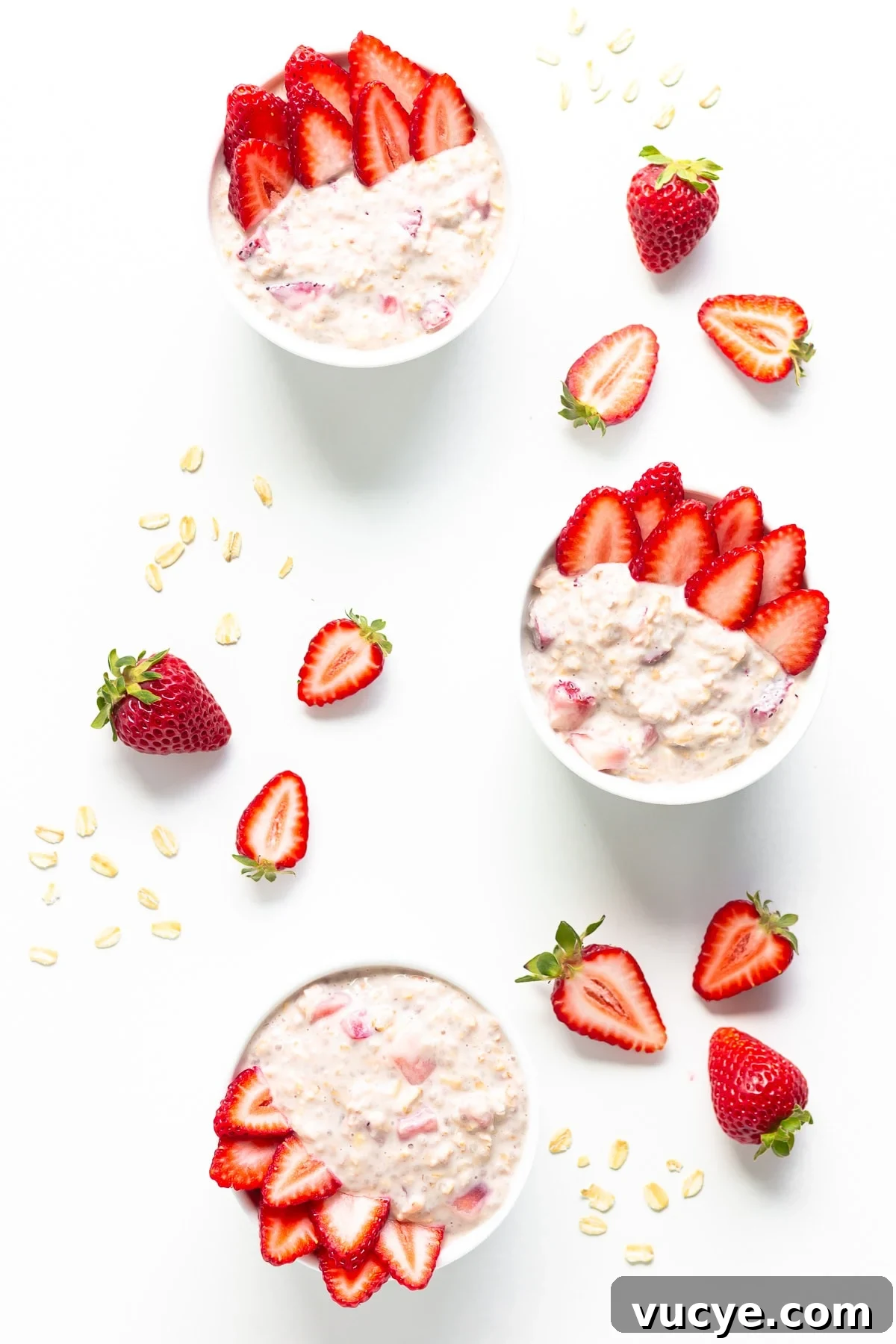 Must-Try Strawberry Recipes for Every Season 5 Three small bowls of strawberry overnight oats garnished with fresh strawberry slices.
