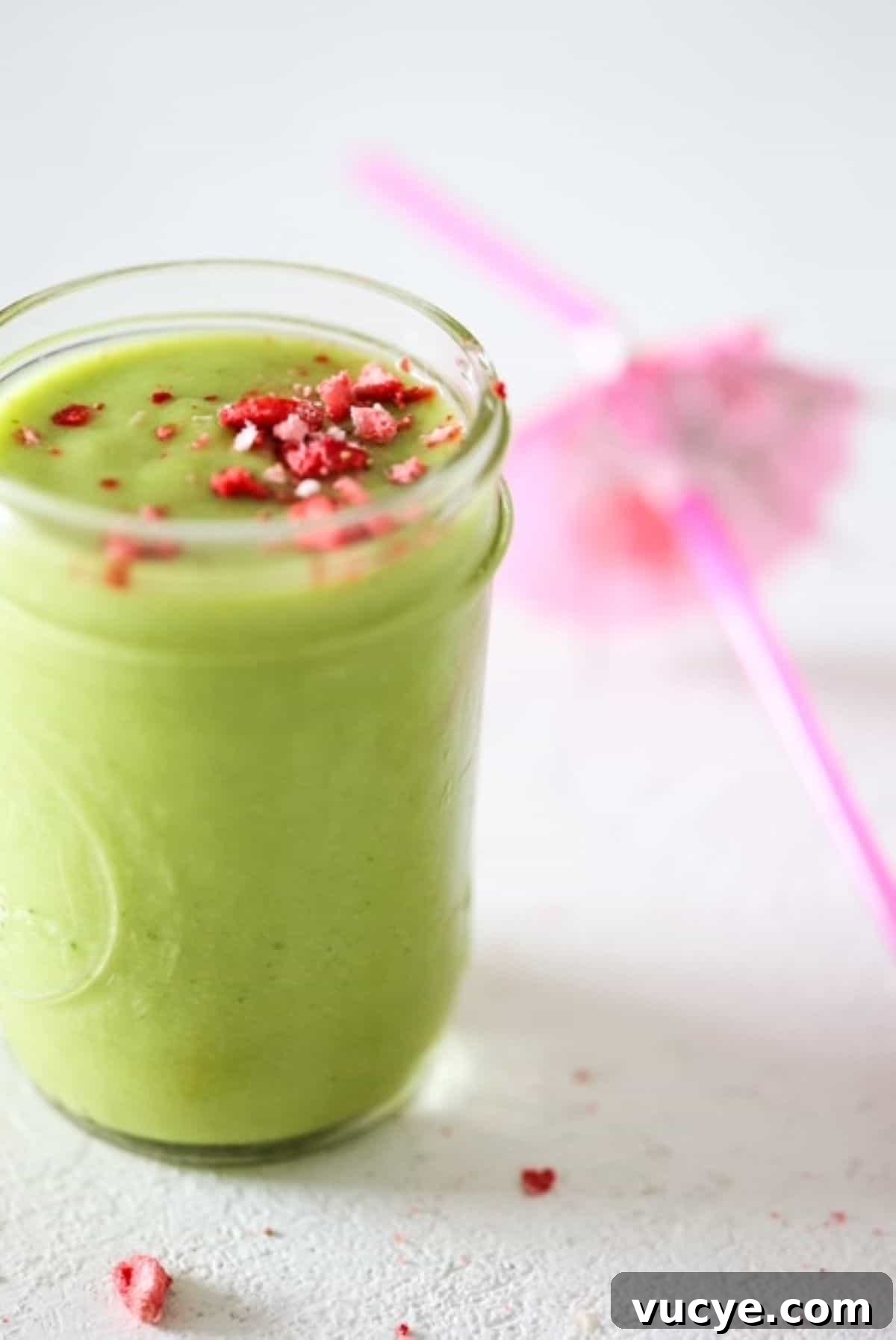 Island Green Tropical Smoothie Recipe — Refreshing Pineapple & Kale Blend 2 One green smoothie in a mason jar with a pink tropical straw to the side.