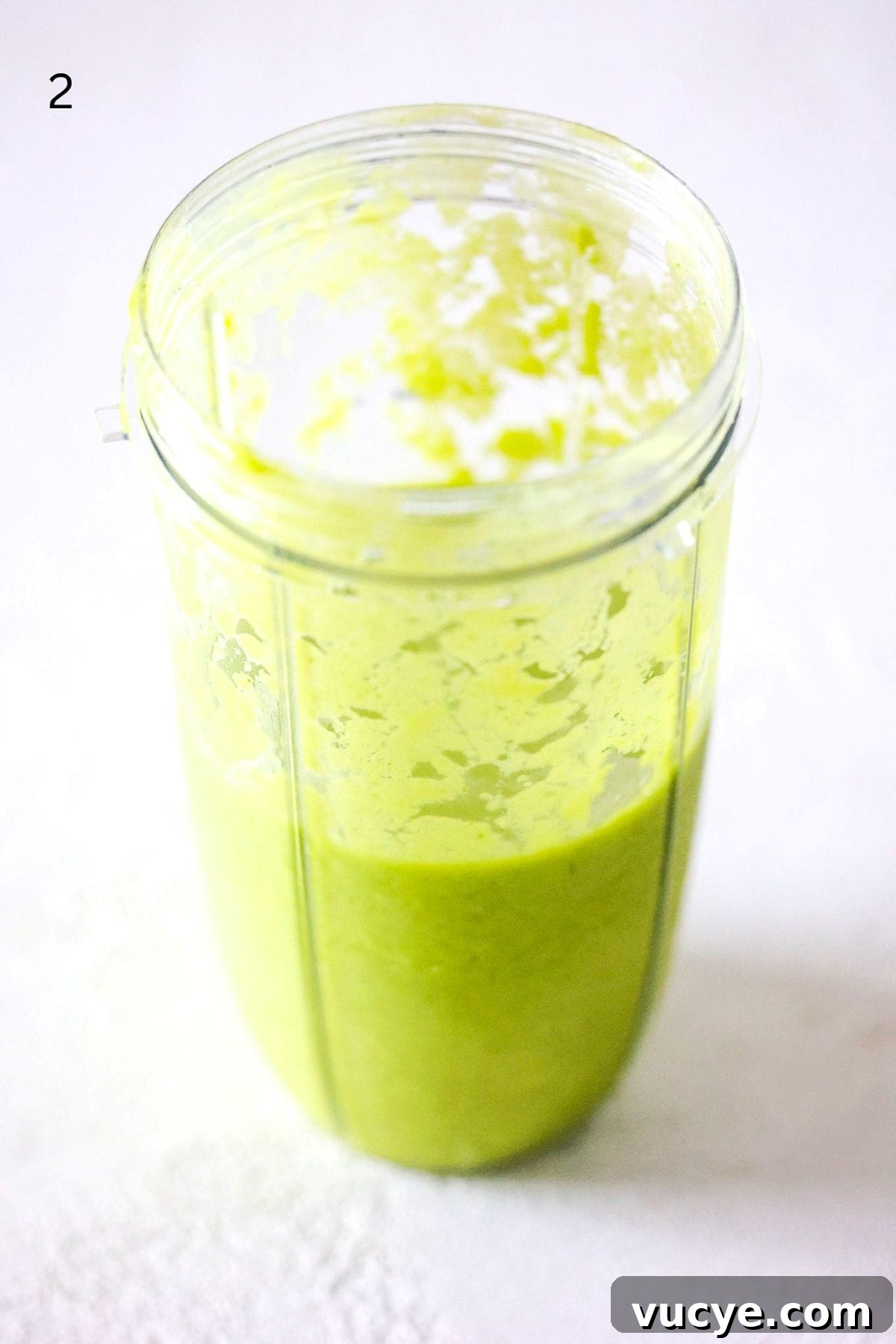 Island Green Tropical Smoothie Recipe — Refreshing Pineapple & Kale Blend 5 Tropical green smoothie in a NutriBullet Pro blender container.