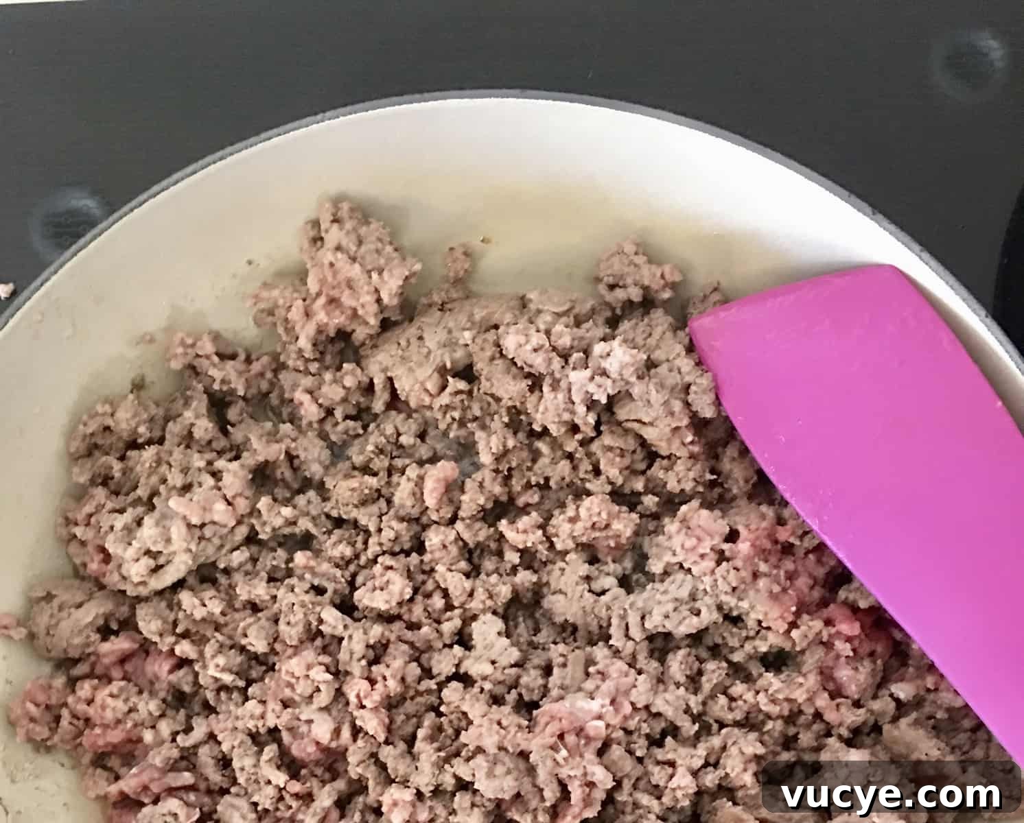 ground beef cooking on stove.