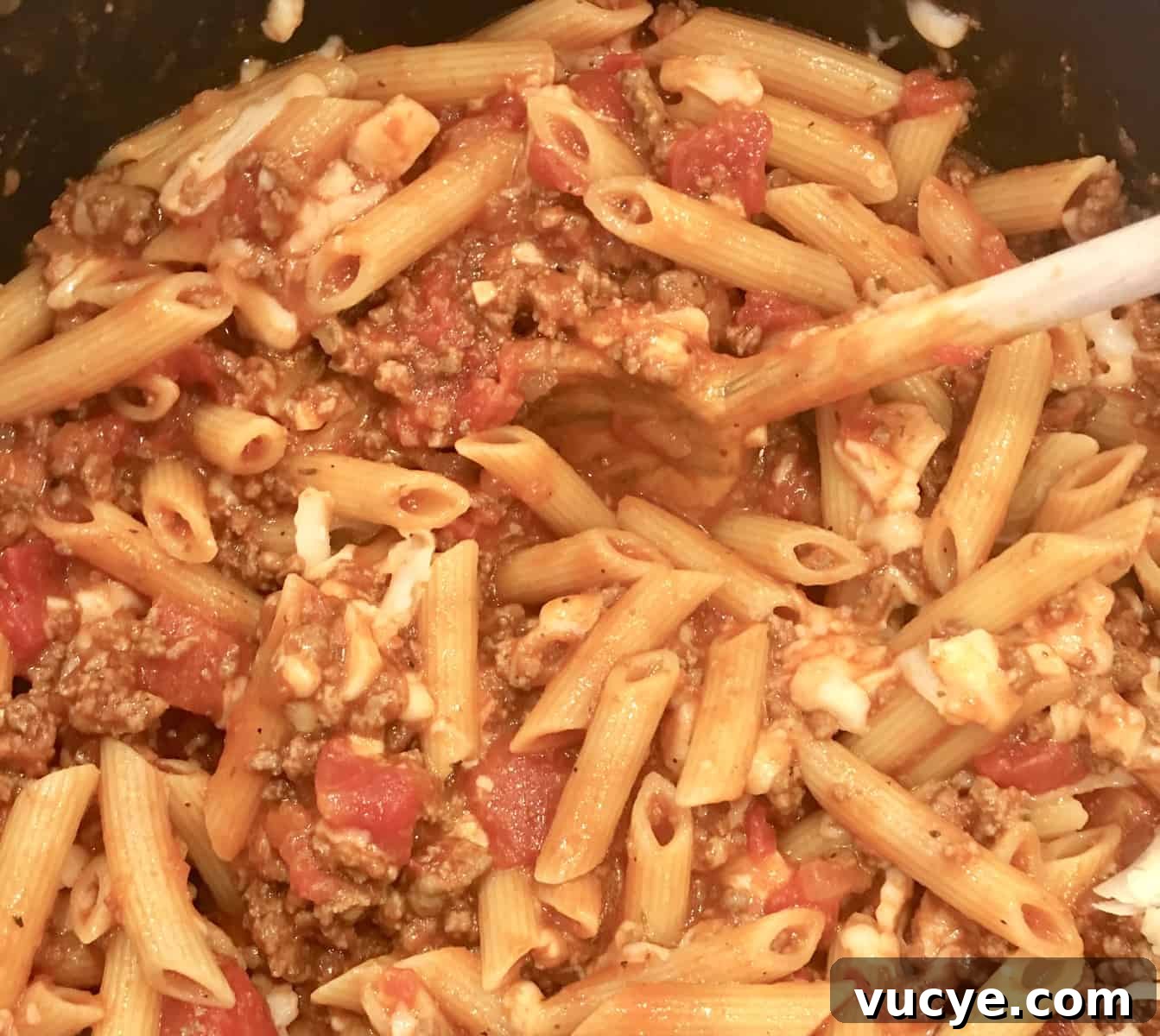 baked ziti with meat sauce in a pot.