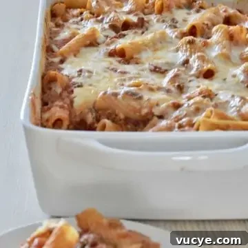Baked Ziti with meat sauce in a white baking dish.