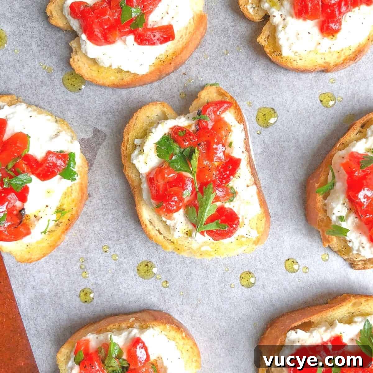 crostini appetizer on a plate with ricotta cheese and peppers