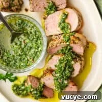 Grilled Pork Tenderloin with Chimichurri Sauce 14 A plate of sliced pork tenderloin with chimichurri on top.