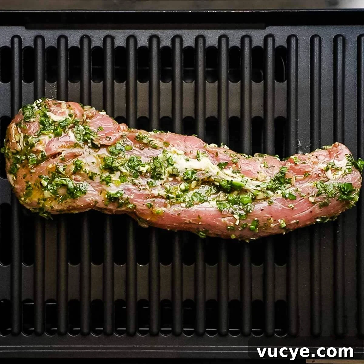 Grilled Pork Tenderloin with Chimichurri Sauce 9 marinated pork tenderloin placed on a grill