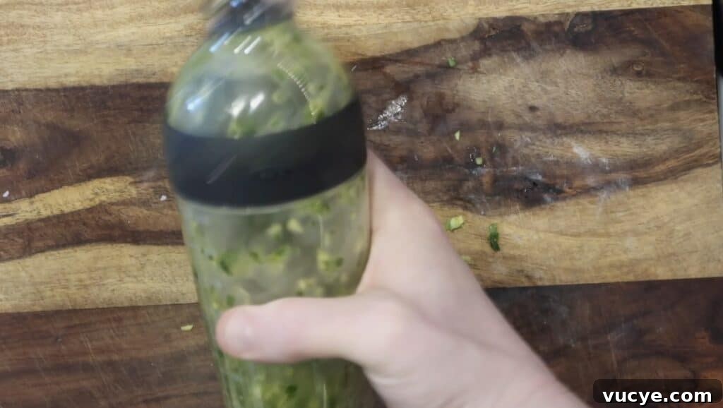 Instant Pot Ginger Scallion Chicken and Rice Bowl 13 Shaking oil in shaker