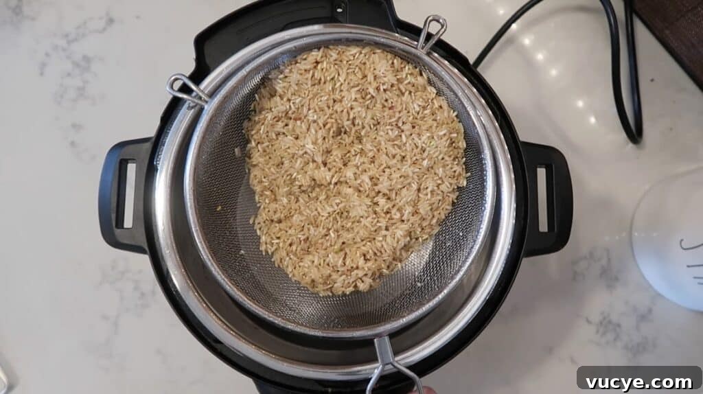 Instant Pot Ginger Scallion Chicken and Rice Bowl 3 Rinsed brown rice being added to Instant Pot