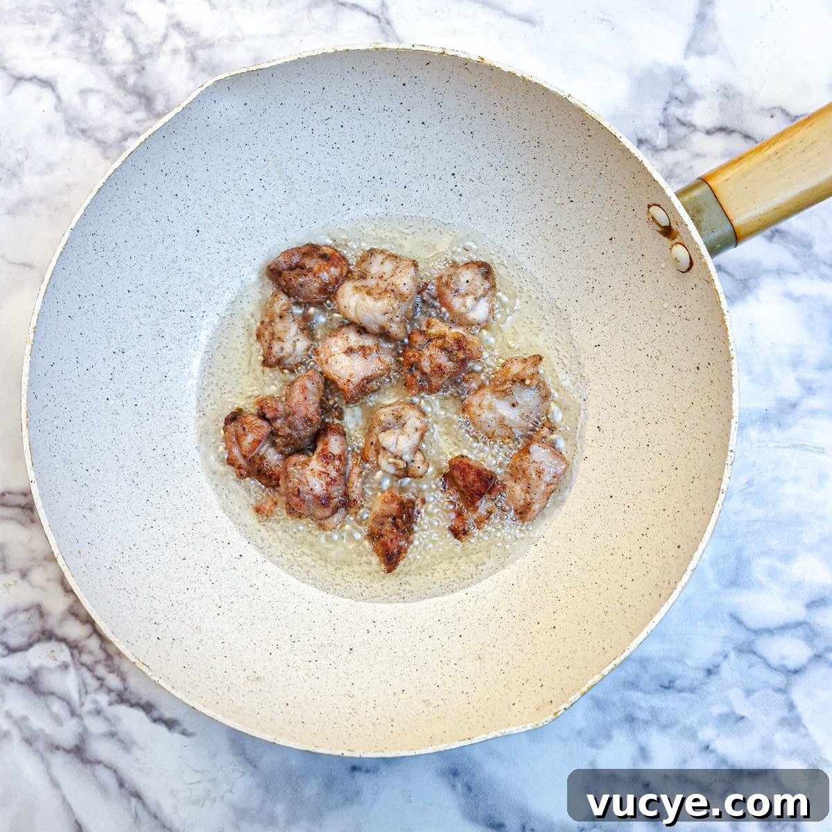 Crispy Salt and Pepper Chicken Recipe for Dinner 10 Browned crispy chicken pieces in a wok.