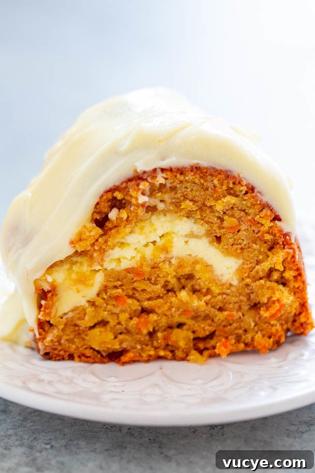 Carrot Cake Cupcakes with Vanilla Cream Cheese Frosting Recipe 14 A slice of Carrot Apple Cream Cheese Tunnel Cake with Cream Cheese Frosting on a plate.
