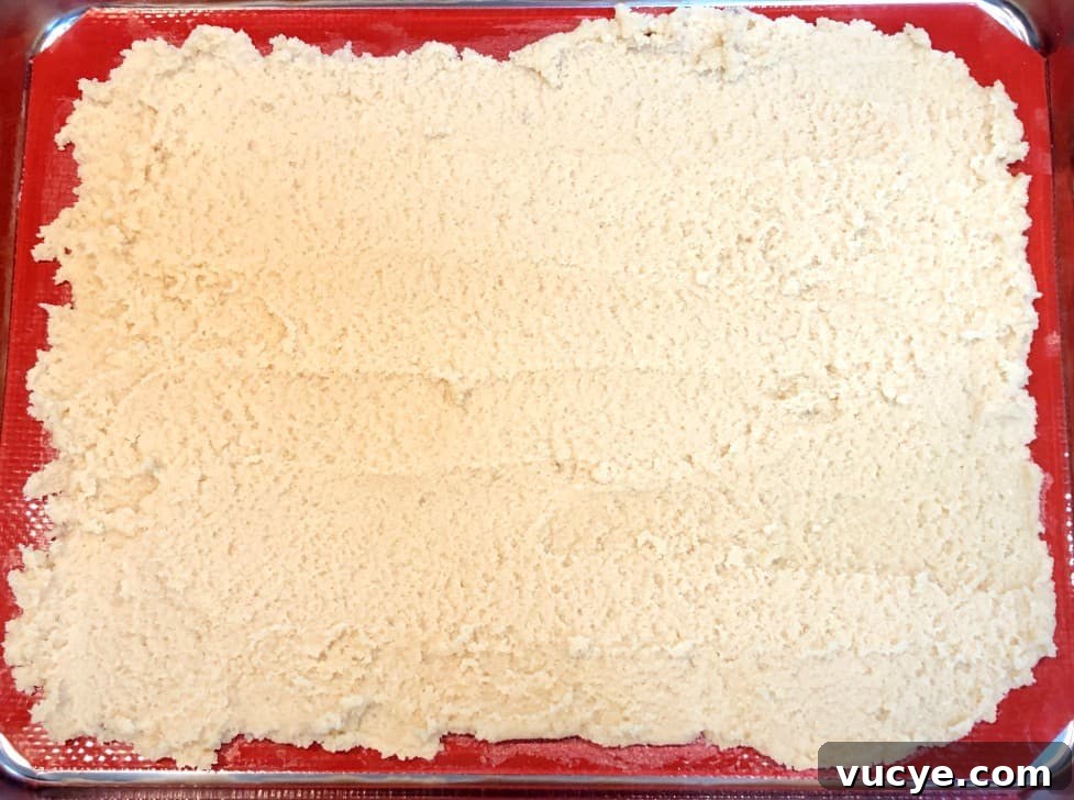 honey almond crust on baking sheet before baking.