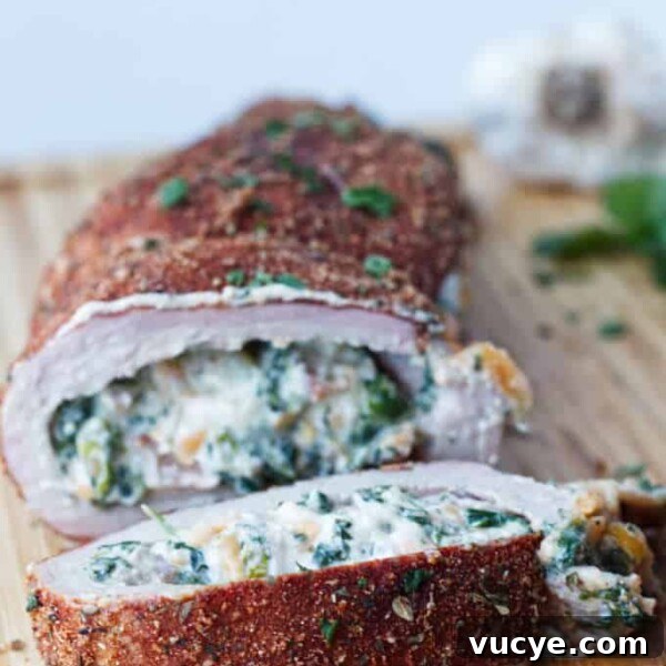 Double-Smoked Ham Techniques for Rich, Smoky Flavor 15 sliced stuffed pork tenderloin with cajun rub and twine holding it together, cheese stuffing, cilantro and garlic cloves sitting on wood