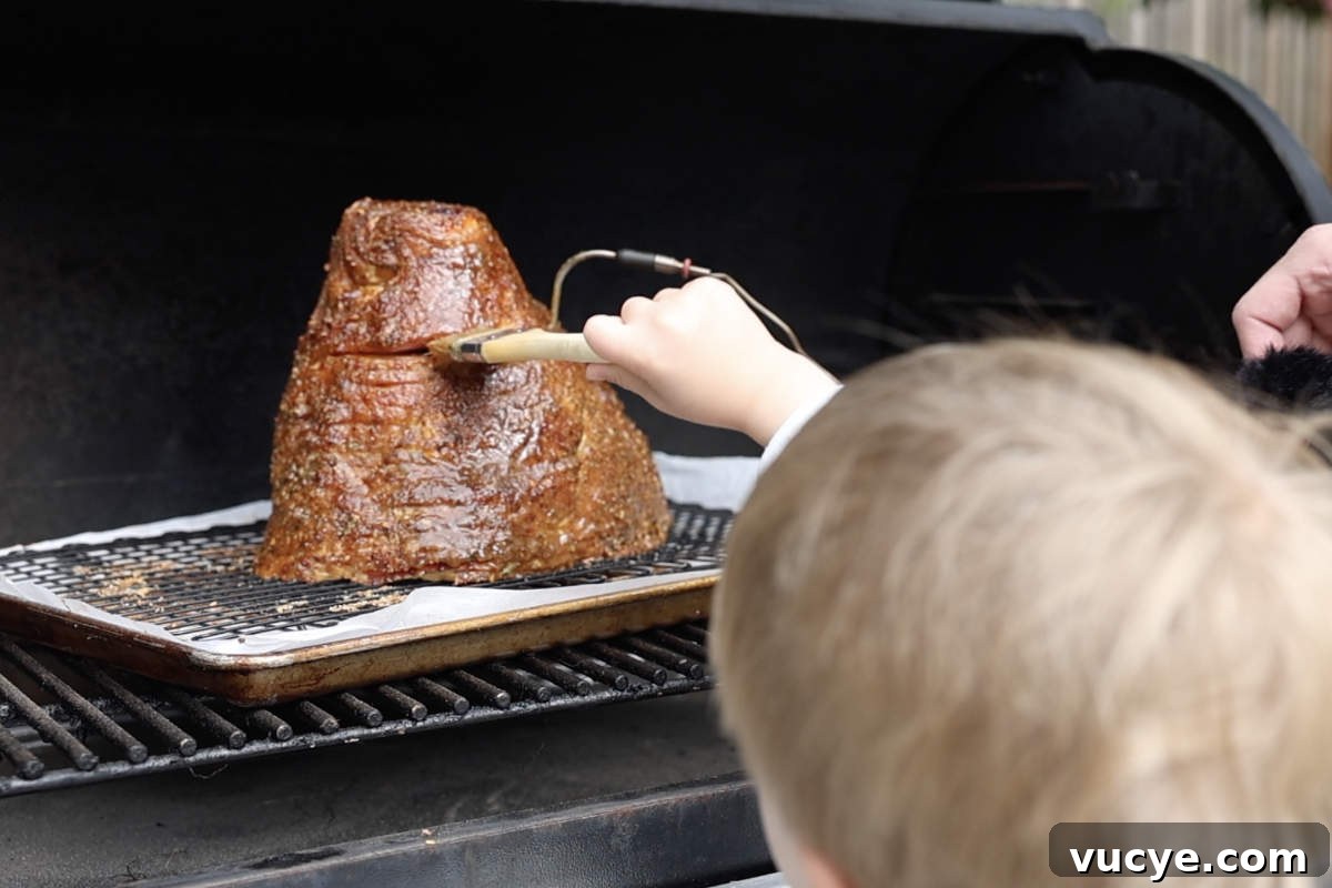 Double-Smoked Ham Techniques for Rich, Smoky Flavor 9 Brushing glaze on the ham while it is on the Traeger.