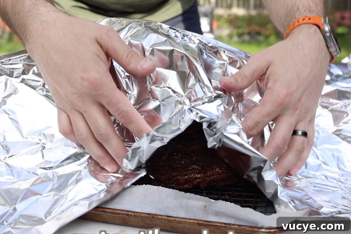 Double-Smoked Ham Techniques for Rich, Smoky Flavor 10 Putting foil over the double smoked ham before letting it rest.