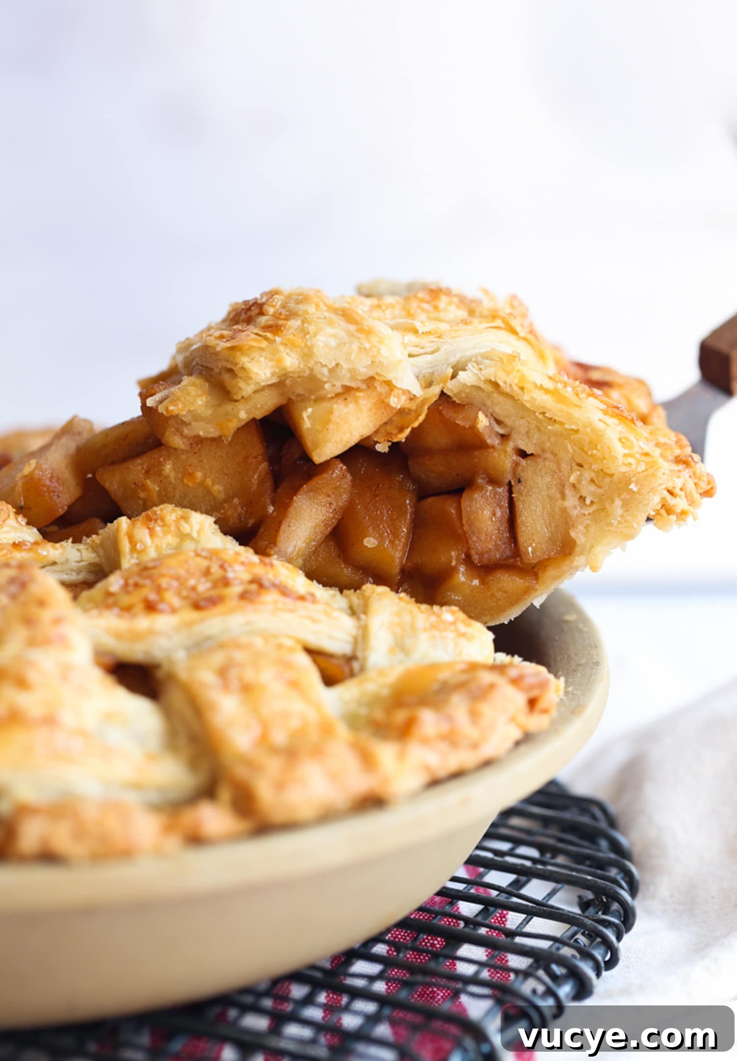 Easy Homemade Apple Pie - The Best Apple Pie Recipe! A pie server serving a slice of apple pie from a pie plate