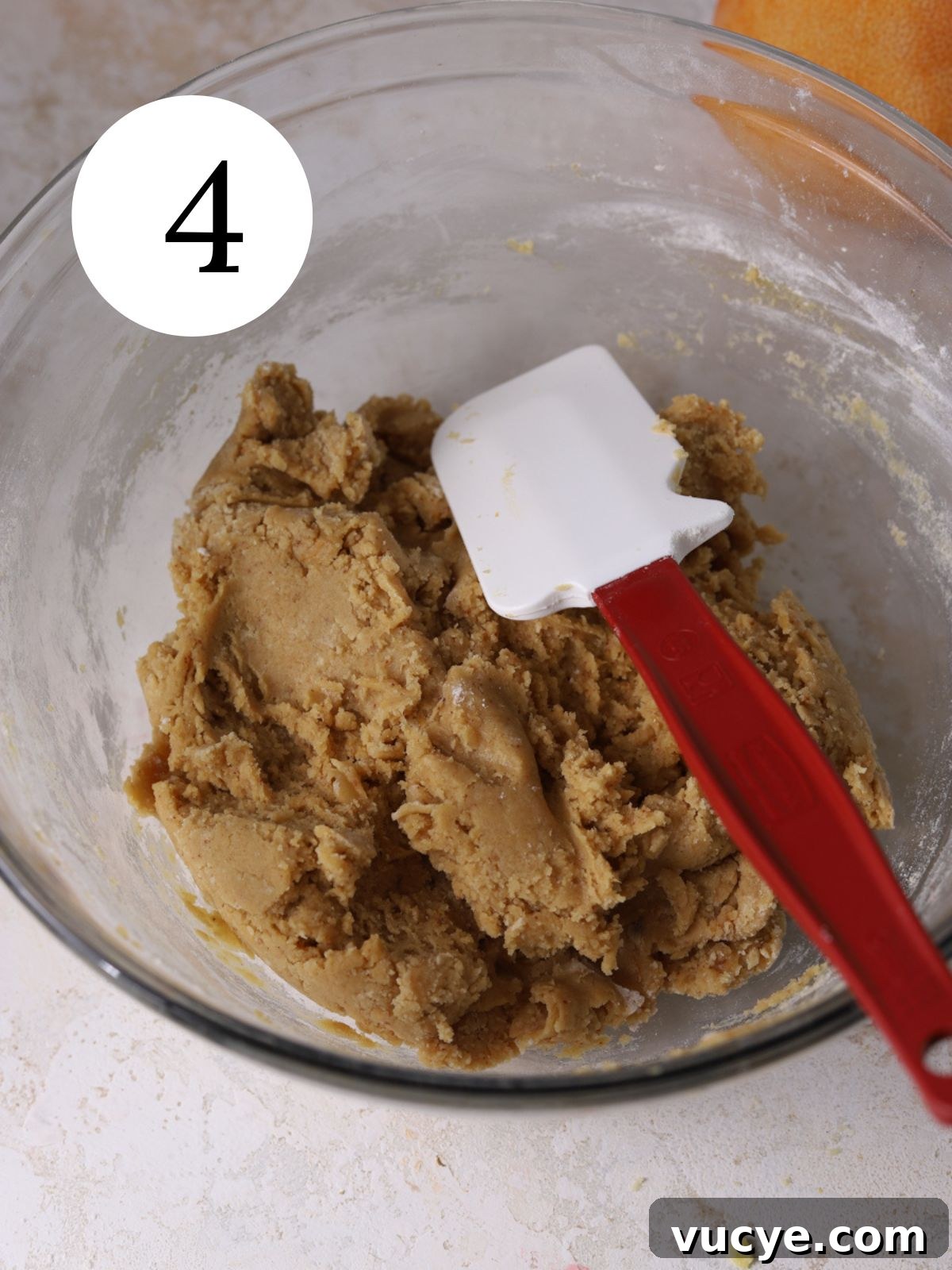 Zesty Grapefruit Cookies: Bright Citrus Cookie Recipe 7 Cookie dough in a glass bowl with a spatula.