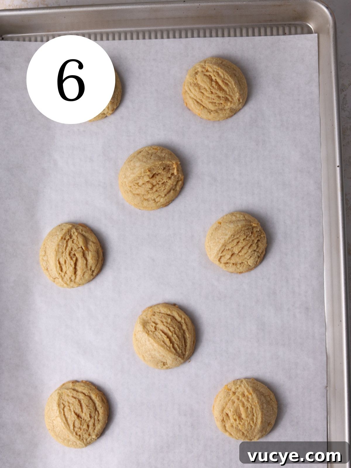 Zesty Grapefruit Cookies: Bright Citrus Cookie Recipe 9 Grapefruit cookies on a baking sheet lined with parchment paper.