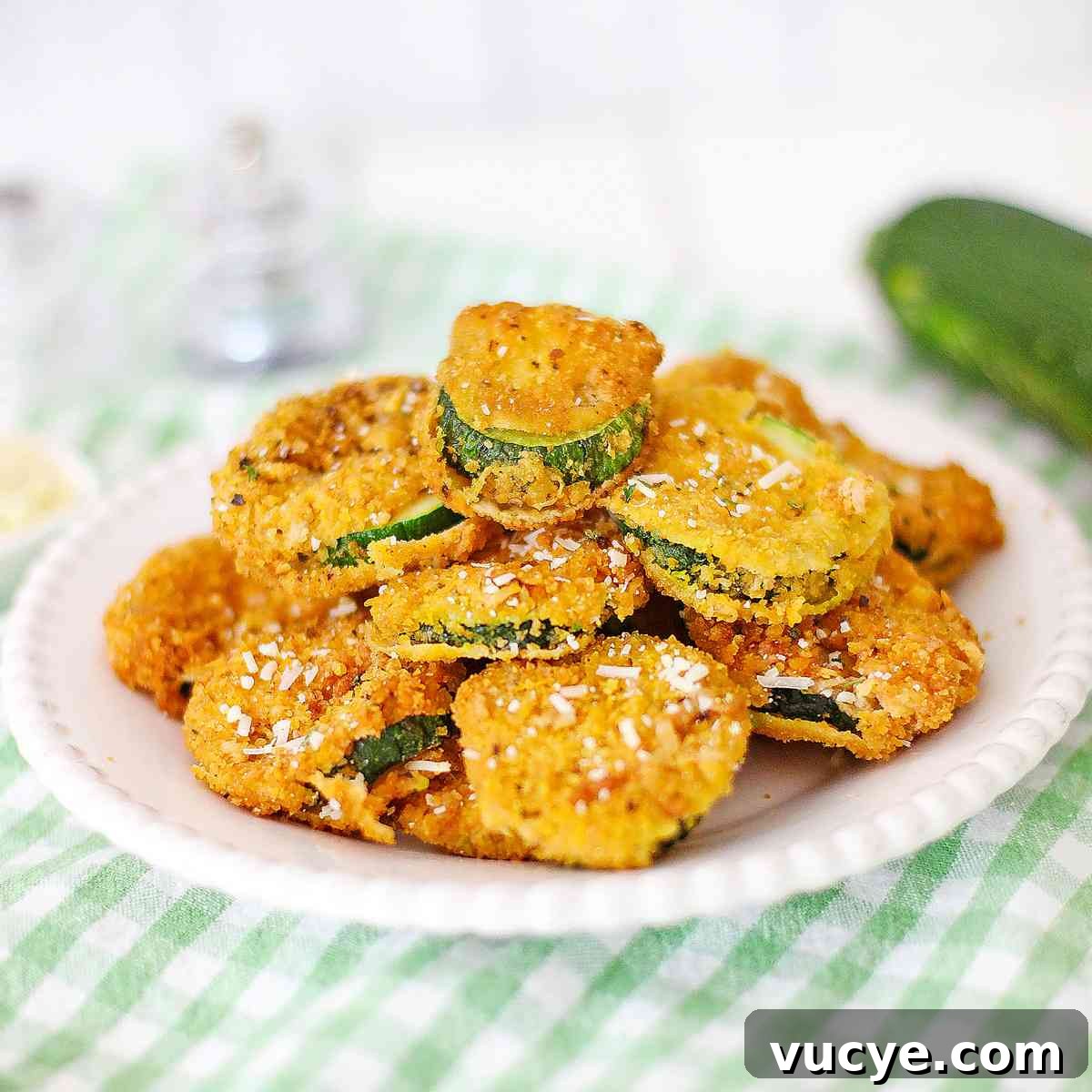 Fried Zucchini on a plate with a green napkin.