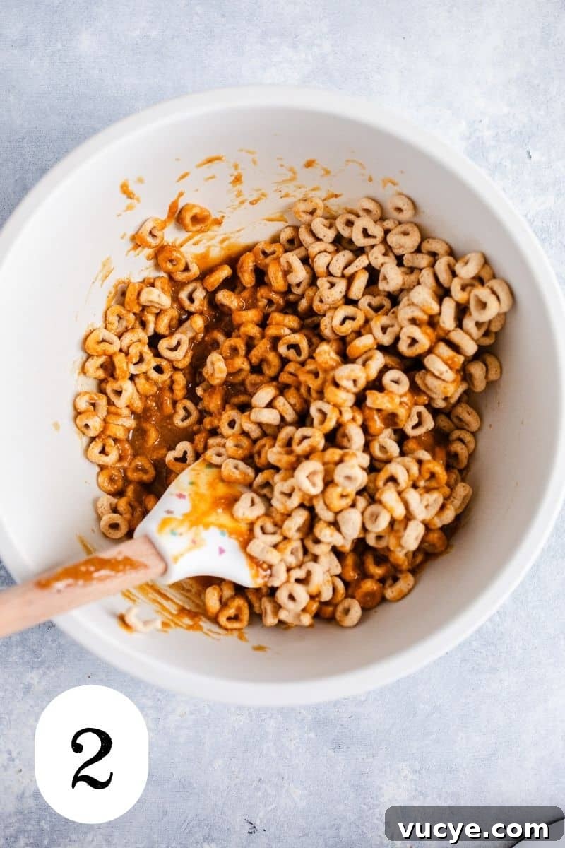 3-Ingredient Peanut Butter Cereal Bites Recipe 5 Cereal and peanut butter in a mixing bowl.