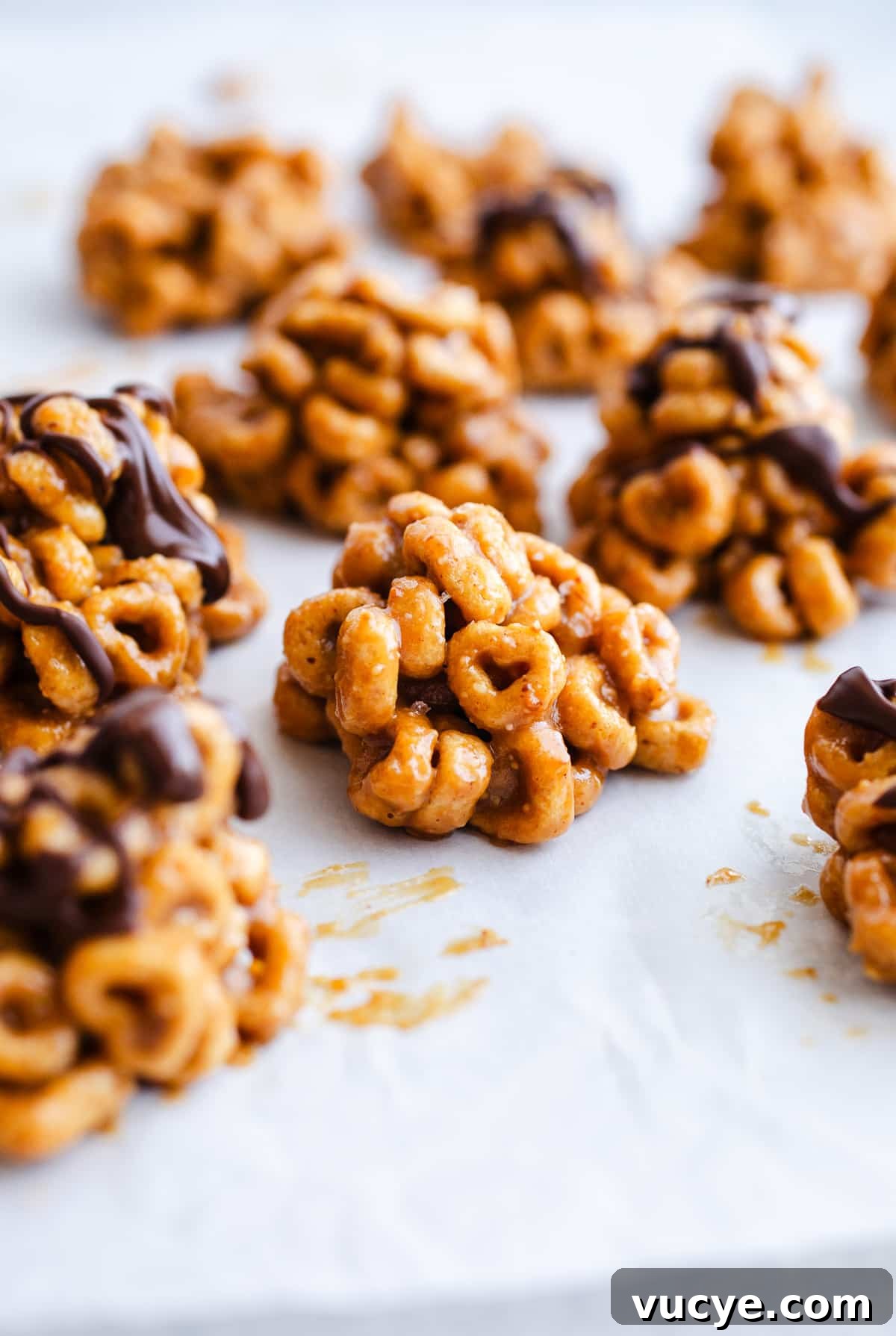 3-Ingredient Peanut Butter Cereal Bites Recipe 8 Cereal bites on a piece of parchment paper.