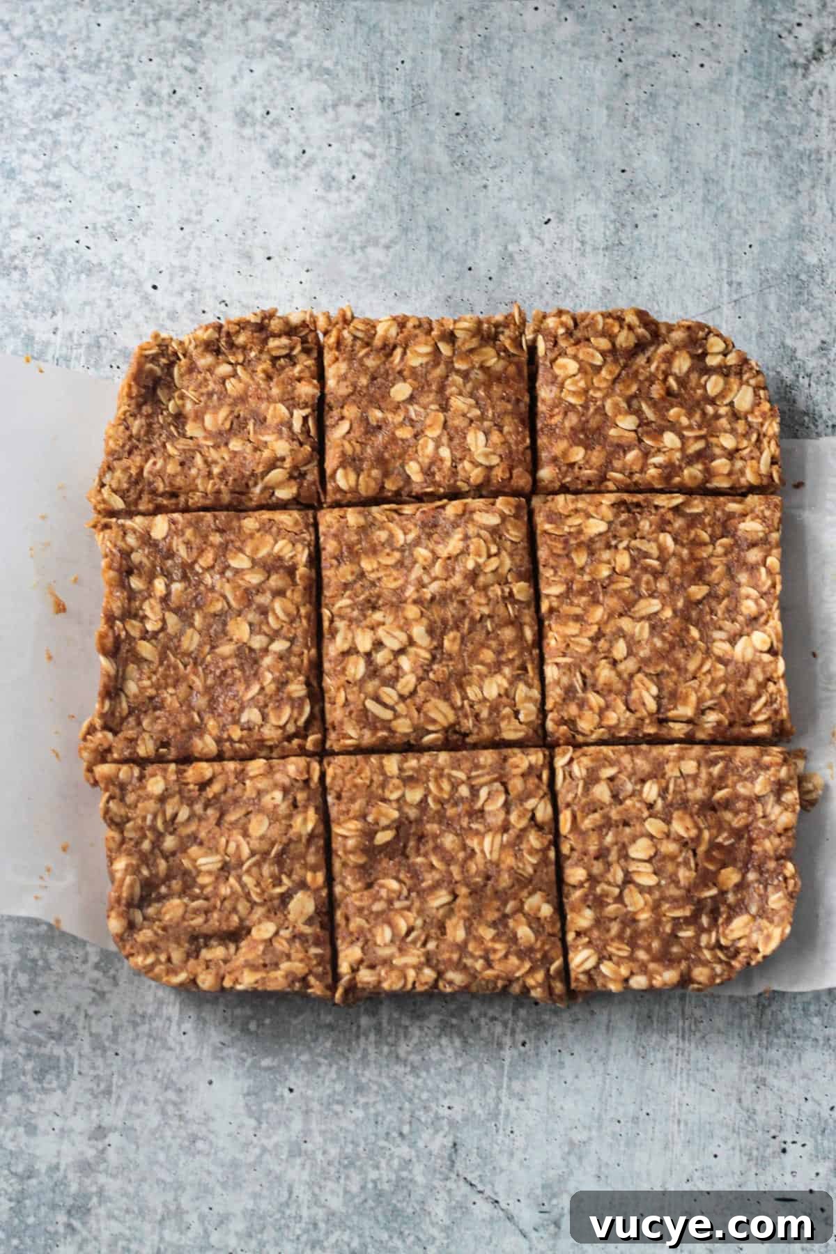No-Bake Peanut Butter Oat Bars — Chewy, Gluten-Free Snack 6 Square of oatmeal bars cut into 9 slices.