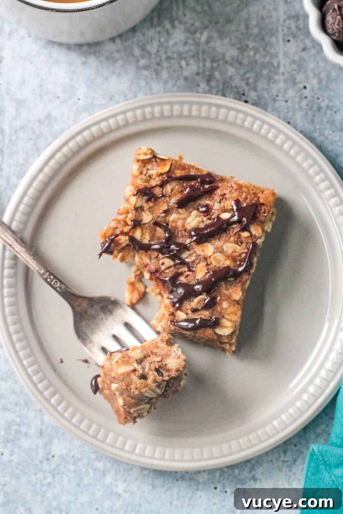 No-Bake Peanut Butter Oat Bars — Chewy, Gluten-Free Snack 8 One bar on a plate next to a bite on a fork.