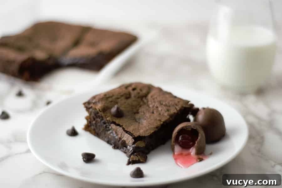 Chocolate Cherry Brownies with Gooey Chocolate Ganache 5 Chocolate Covered Cherry Cordial Brownies in a pan and one on a plate