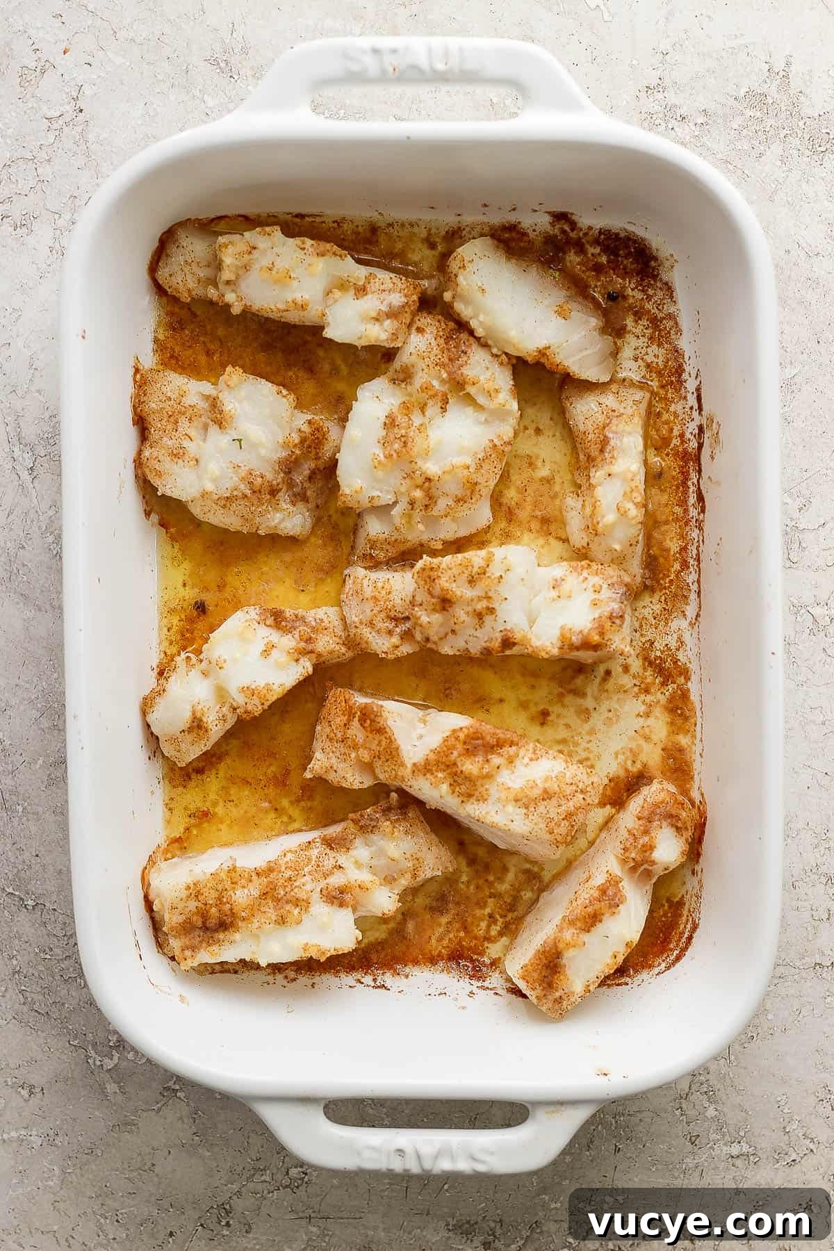 Crispy Cod Tacos with Zesty Slaw and Lime Crema 4 Cod filets baked in a casserole dish.