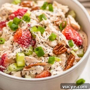 Top Rotisserie Chicken Recipes You’ll Want to Try 10 White bowl with strawberry pecan chicken salad topped with green onion and pecans.