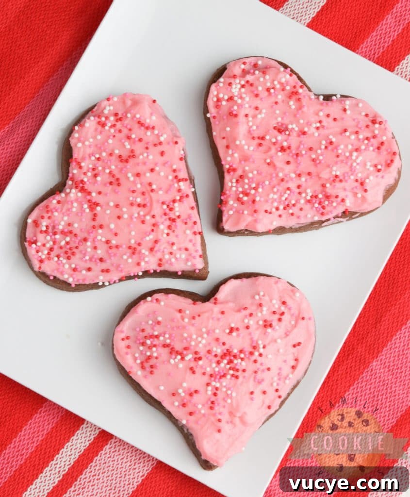 Soft chocolate sugar cookies decorated with frosting and sprinkles.
