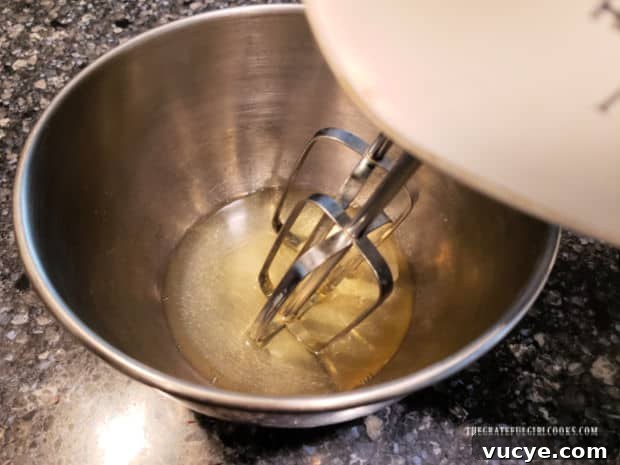 Beaten egg whites Two egg whites are beaten using an electric mixer.