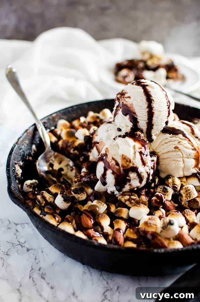 Rocky Road Brownies Recipe: Chewy Chocolate Fudge with Marshmallows and Nuts 3 Pan of rocky road brownies with nuts and toasted marshmallows topped with ice cream