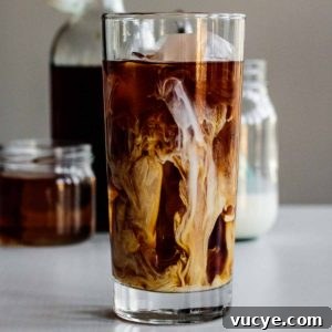 Starbucks Vanilla Sweet Cream Cold Brew Recipe & Tips 5 a tall glass of vanilla sweet cream cold brew with cream, syrup and coffee in the back