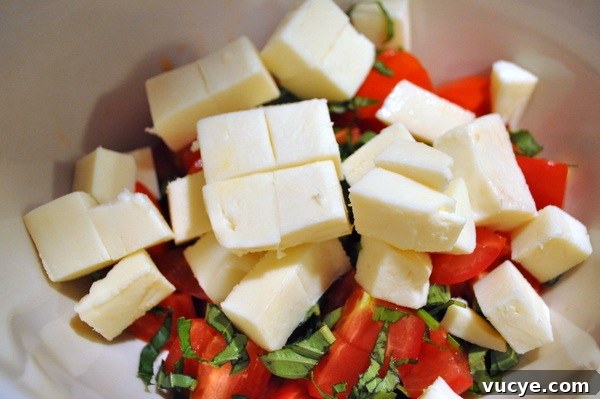 Caprese Salad: Fresh Tomato, Mozzarella & Basil Recipe 7 Layer tomatoes and mozzarella on a platter, tucking basil in between. For a rustic version, toss them together in a bowl.