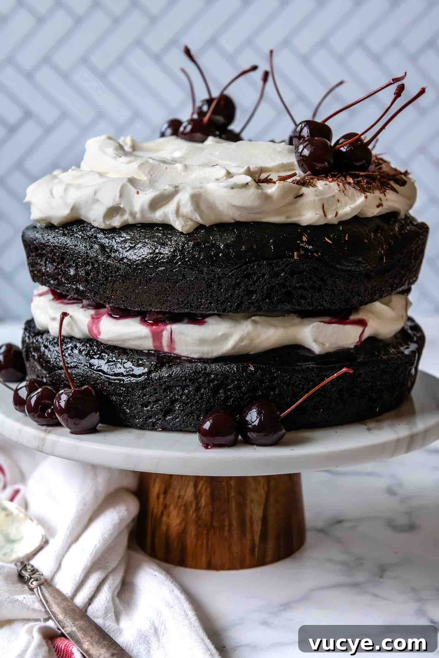 Cake completed and sitting on a cake stand.