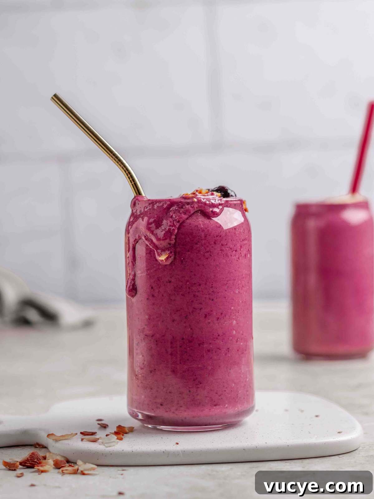Mixed berry smoothies with almond butter in a serving glass..