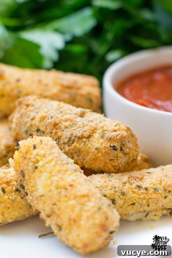 Crispy Gluten-Free Air Fryer Mozzarella Sticks Recipe 2 gluten free air fryer mozzarella sticks with marinara on tray
