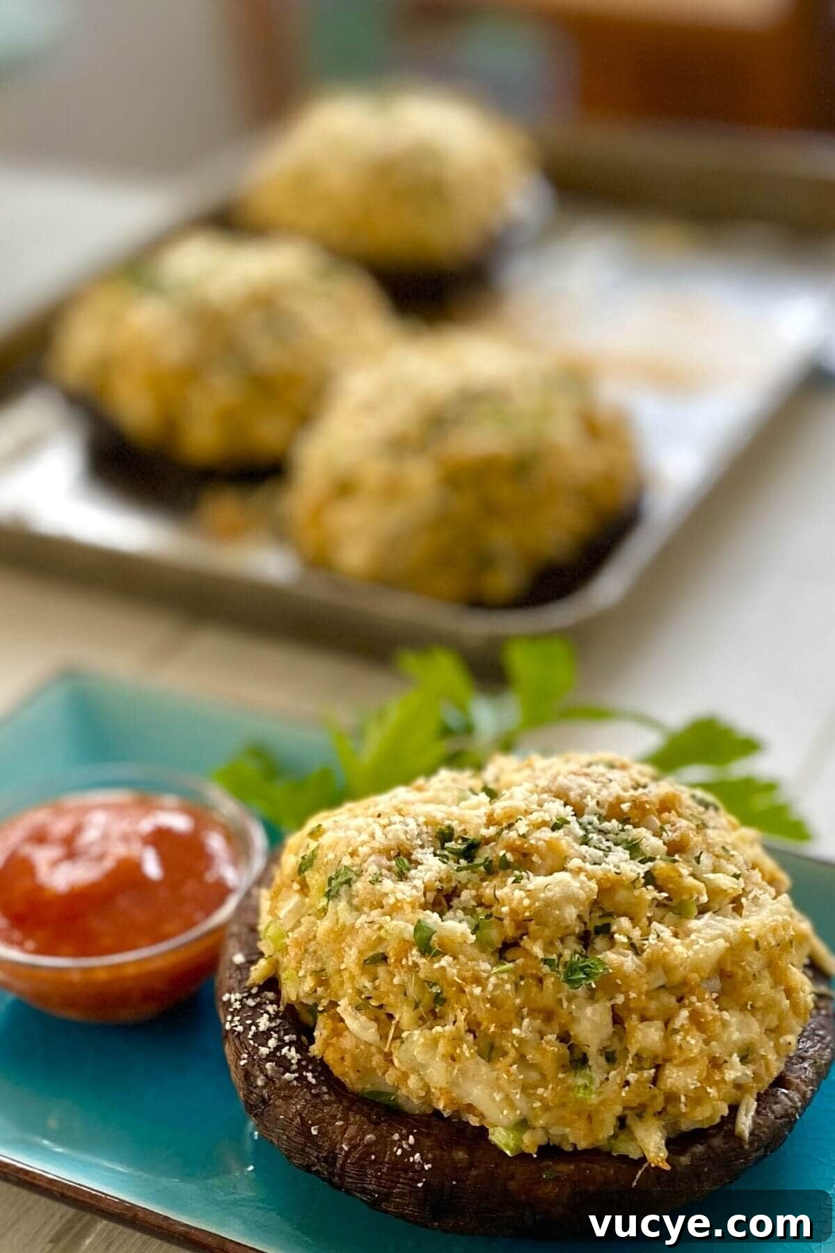 Crab-Stuffed Portobello Mushrooms with Garlic Herb Filling 12 crab stuffed portobello with sauce.