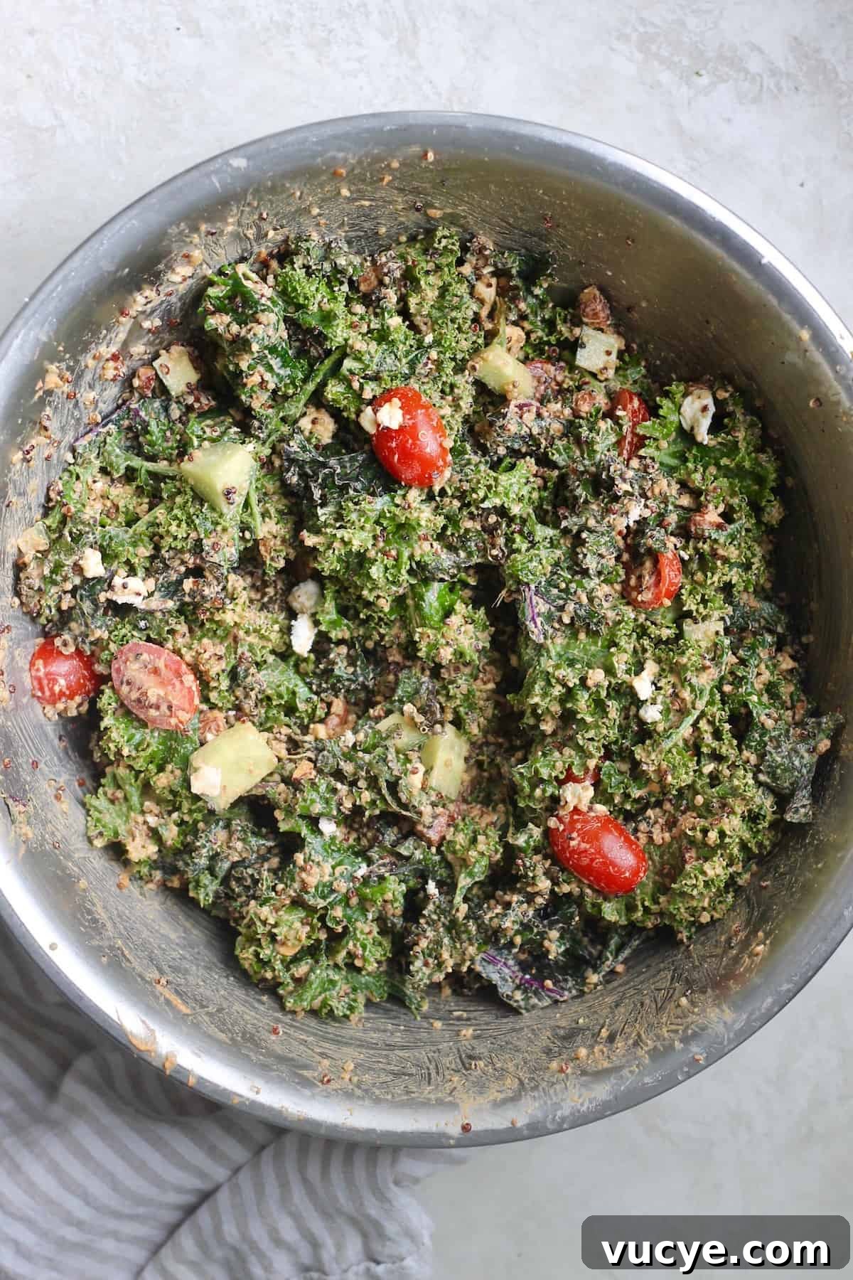mixing bowl with tossed kale salad.