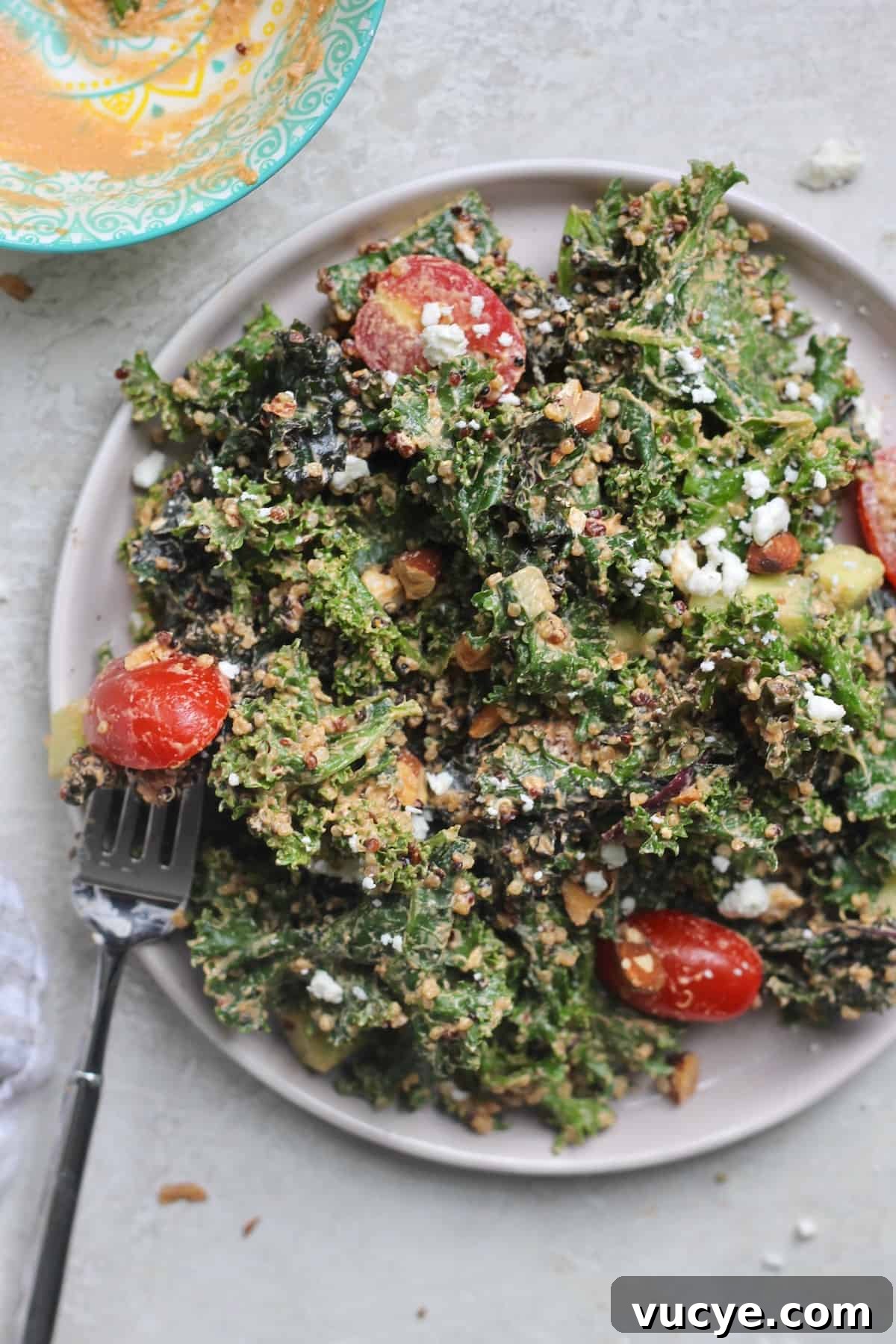 fork with kale salad on plate.