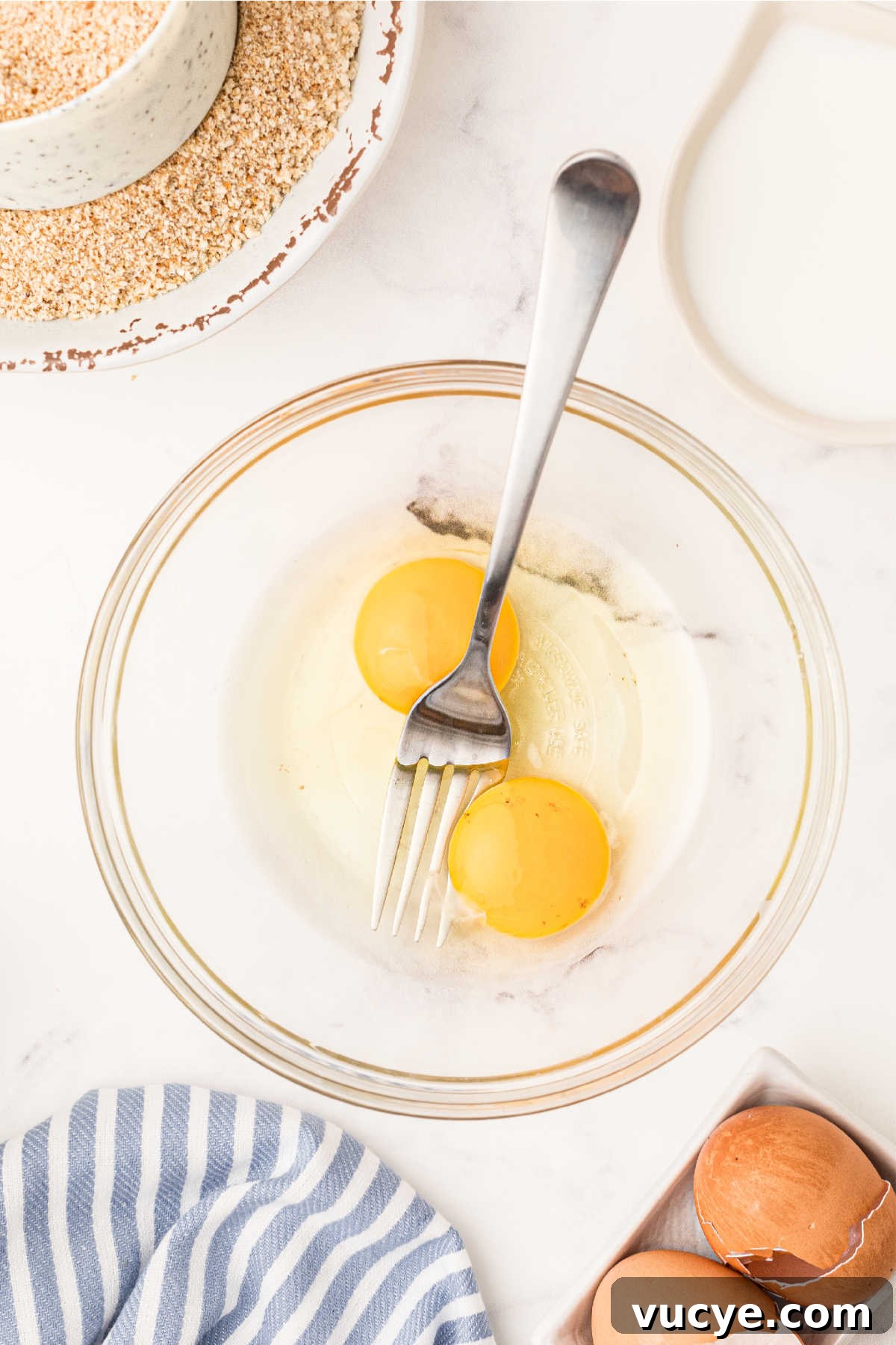 Crispy Fried Boudin Balls: Where to Find & How to Enjoy 6 A mixing bowl with eggs about to be beaten.