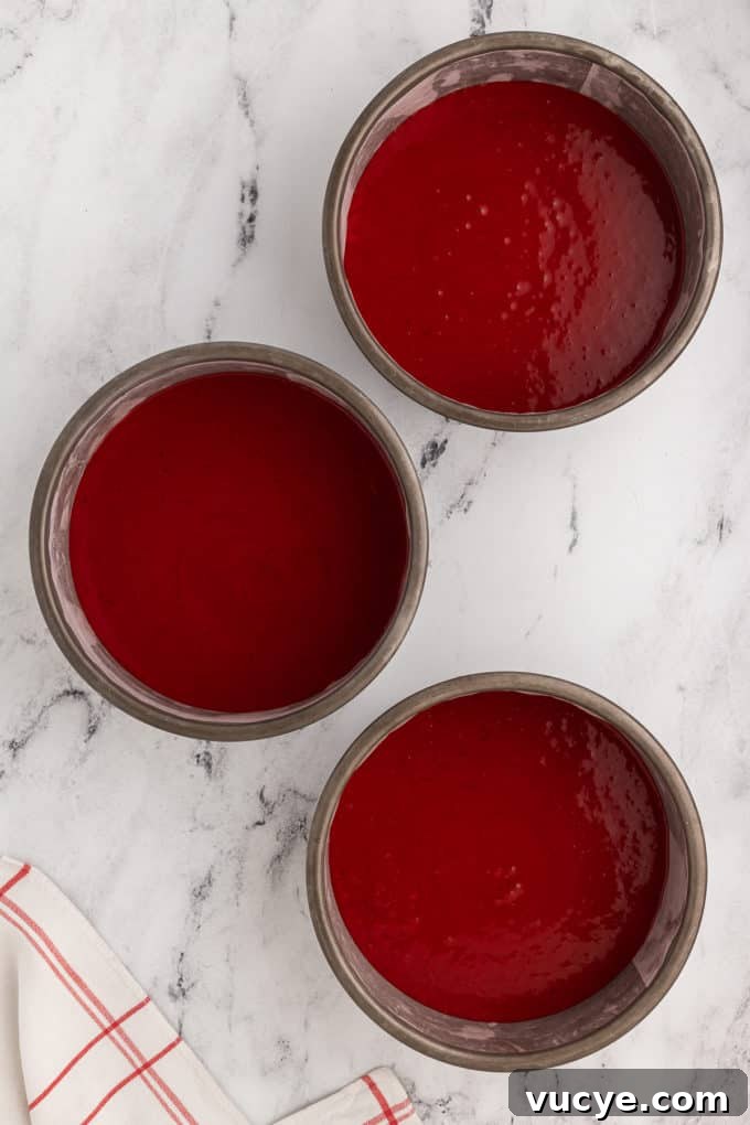 Homemade Red Velvet Cake Recipe From Scratch 13 three cake pans filled with red velvet cake batter