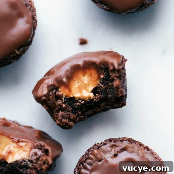Peanut butter brownie bites with a bite taken out, revealing a melting peanut butter center.