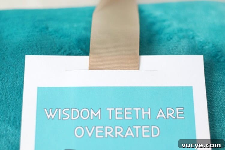 Wisdom Tooth Recovery Gift Basket Ideas with Printable Card 7 ribbon slid through slit of wisdom teeth card