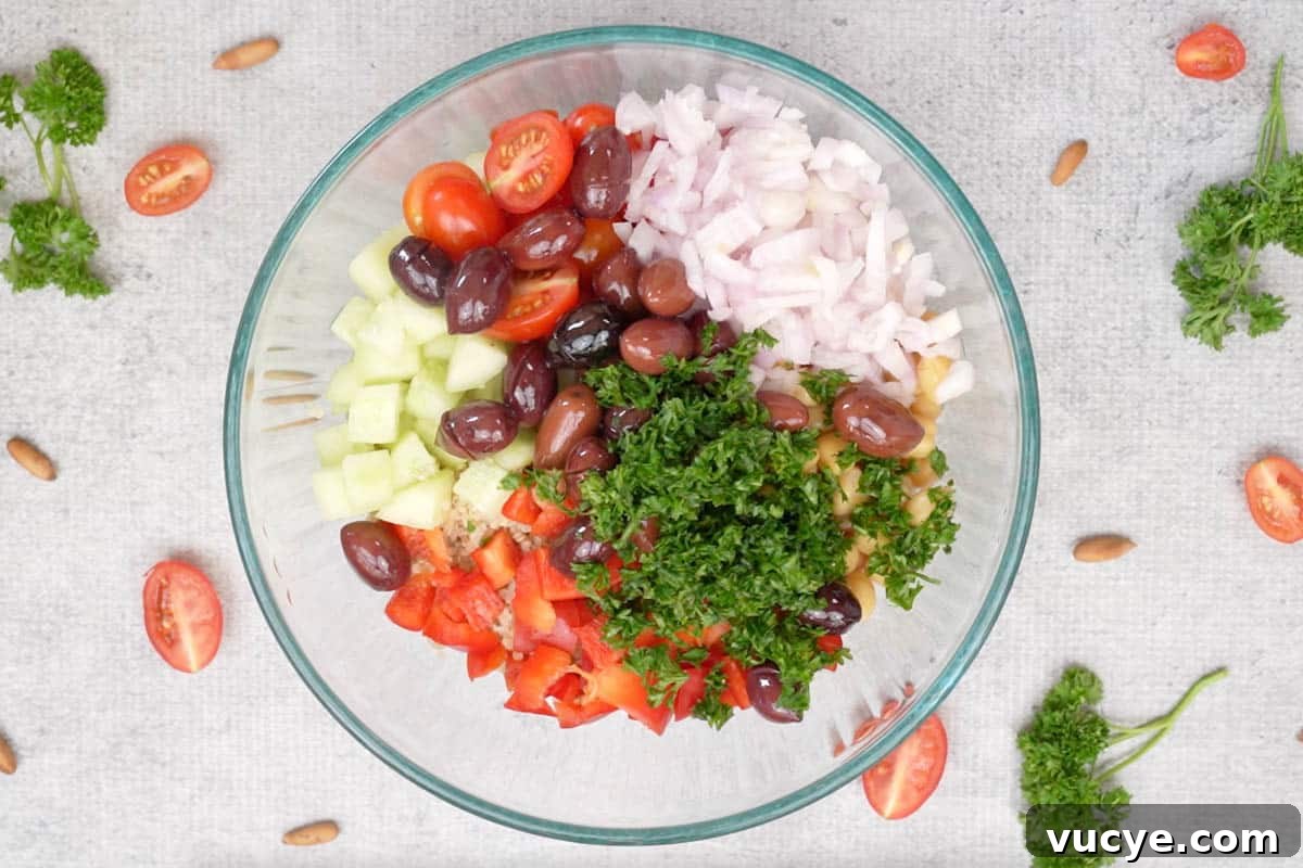 All the salad ingredients added to a bowl.