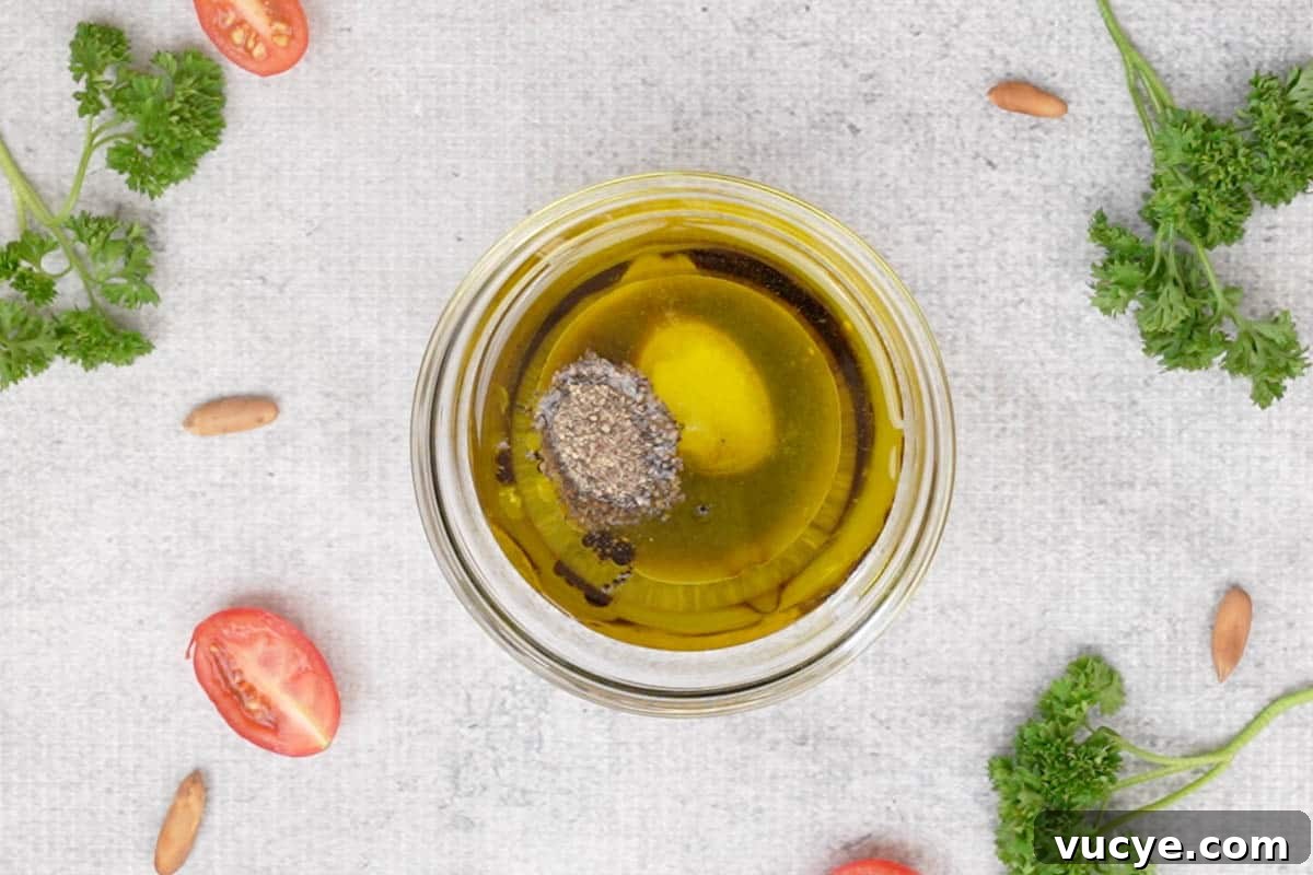 Dressing ingredients added to a bowl.
