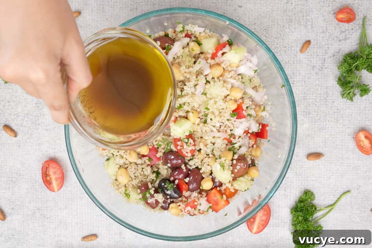Pouring the dressing over the salad.